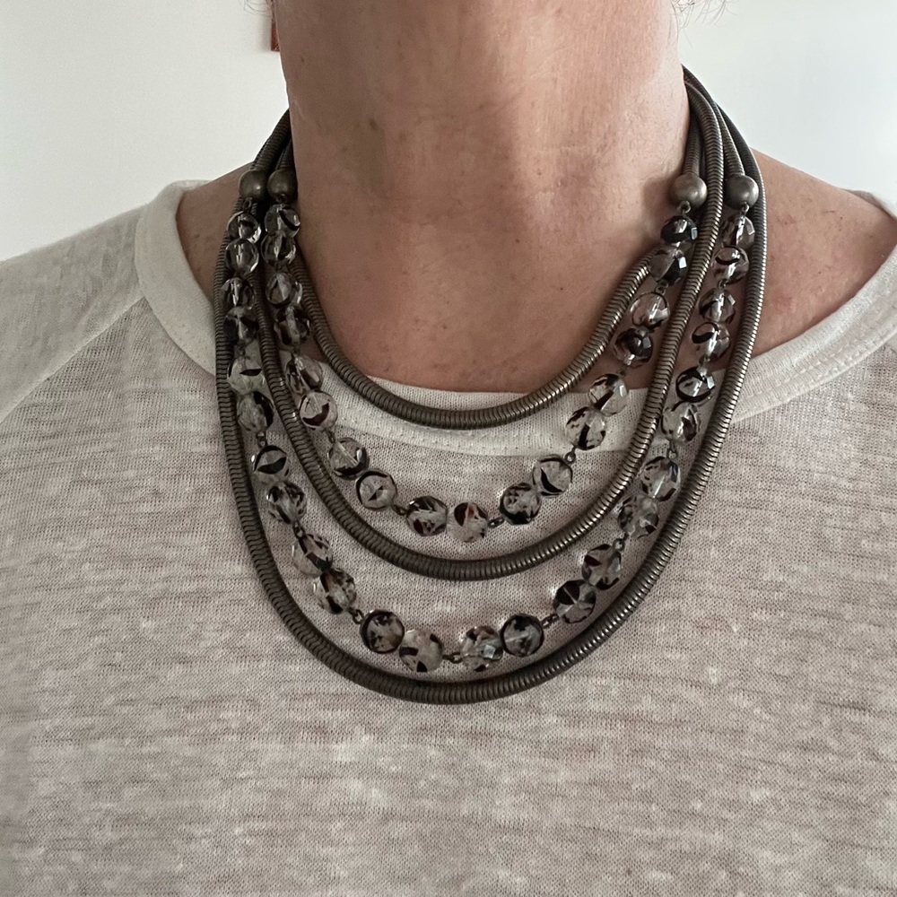 Five strand metal necklace, two of them black and white crystal.